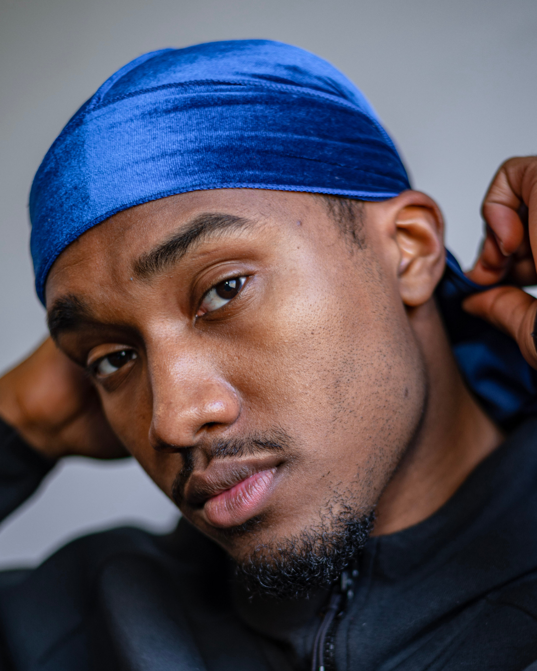Man wearing a silk durag to protect braids while sleeping